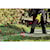 FLEXVOLT Brushless Cordless Handheld Axial Blower being used to blow grass blades off a passageway