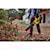 FLEXVOLT Brushless Cordless Handheld Axial Blower being used to clear leaves off  ground
