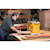 12 and half inch Thickness Planer with Three Knife Cutter Head being used by a person on wooden plank.