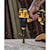 Atomic brushless compact half inch drill driver drilling  wooden surface.