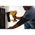 XR 18 GA Cordless Brad Nailer in action on a wooden cabinet built into the wall