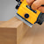 DEWALT Portable Hand Planer being used by a person to even out a wooden edge