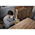 User sanding the side of a wooden kitchen cabinet with the DCW220B and the DCB250 battery 