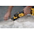ATOMIC Brushless Cordless Oscillating Multi Tool being used by person for scraping up flooring mastics