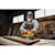 User sanding a wood board with the DCW220B and DCBP520 battery attached 