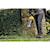LITHIUM ION XR&#174; Brushless, handheld blower with nozzle being used by a person to blow grass blades off  ground. 