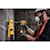 Brushless cordless hammer drill is being used by a person to drill.
