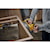 User sanding the side of a wooden kitchen cabinet with the DCW220B and the DCBP520 battery 