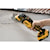 XR Cordless Oscillating Multi Tool being used by person to remove blistered paint from a wall