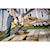 XR&#174; Compact 12 inch Cordless Chainsaw being used by a worker to cut through wooden planks outdoors