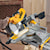 Double bevel sliding compound miter saw being used to cut wood.